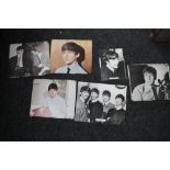 A small quantity of photographs and press cuttings relating to the Beatles, one bearing signatures.