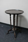 A reproduction oak pedestal table on four way support