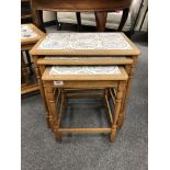 A nest of three tiled oak tables