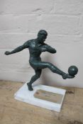 A metal figure - footballer on marble plinth