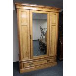 An Edwardian burr walnut mirrored wardrobe