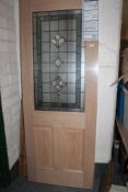 An Avon glazed oak veneer exterior door 76 cm x 198 cm, depth 4.