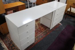 A laminated white four drawer chest and matching desk