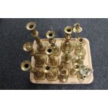 A tray of antique and later brass candlesticks