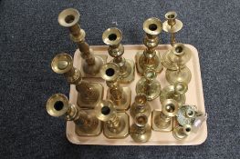 A tray of antique and later brass candlesticks