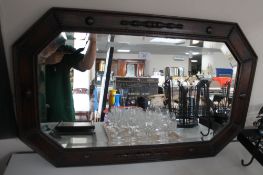 An Edwardian oak bevelled mirror