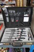 A suitcase of chef knives manufactured by 'Chef-Pro'