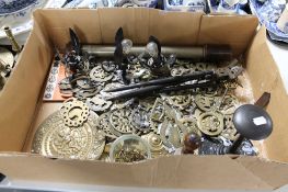 A box of brass, horse brasses, metal lights,