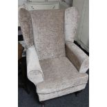 A pair of contemporary armchairs in grey fabric