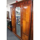 An Edwardian mahogany three piece bedroom suite - triple door wardrobe,