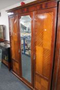 An Edwardian mahogany three piece bedroom suite - triple door wardrobe,