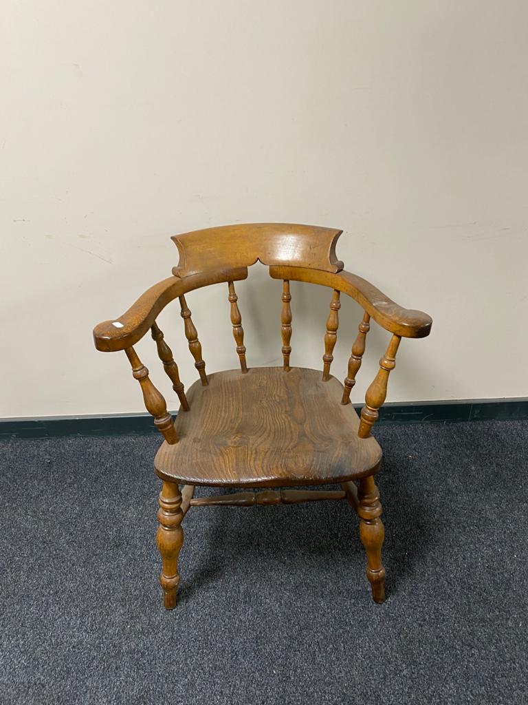 A nineteenth century elm half smoker chair