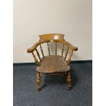 A nineteenth century elm half smoker chair