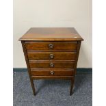 An Edwardian four drawer music cabinet