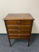 An Edwardian four drawer music cabinet