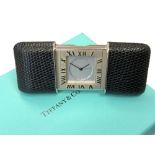 A Purse/Travel Alarm Watch by Tiffany & Co, quartz battery movement, silvered dial signed,