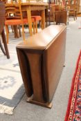 A small Ercol drop leaf table, width 69 cm.