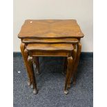 A nest of early twentieth century mahogany tables