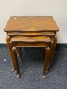 A nest of early twentieth century mahogany tables