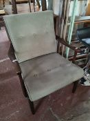 A mid century teak armchair.