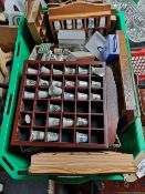 A crate of thimbles and thimble stands