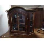 A decorative gilt highlighted wall cabinet