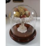An antique glass dome on mahogany plinth containing a marble pedestal stand with fruit