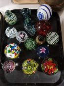 A tray of glass paperweights,