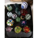 A tray of glass paperweights,