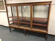 A Victorian mahogany glazed triple door cabinet, width 219 cm, height 172 cm, depth 52 cm.