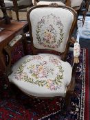 A carved walnut tapestry seated armchair