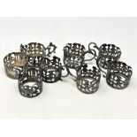 A set of eight ornate Victorian silver cup holders decorated with putti