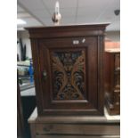 A nineteenth century mahogany cabinet with carved panel door