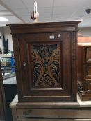 A nineteenth century mahogany cabinet with carved panel door