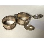 A pair of Lindisfarne silver napkin rings and a boxed pair of spoons depicting St.