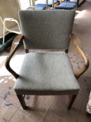 A mid century teak armchair.