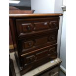 A reproduction three drawer chest