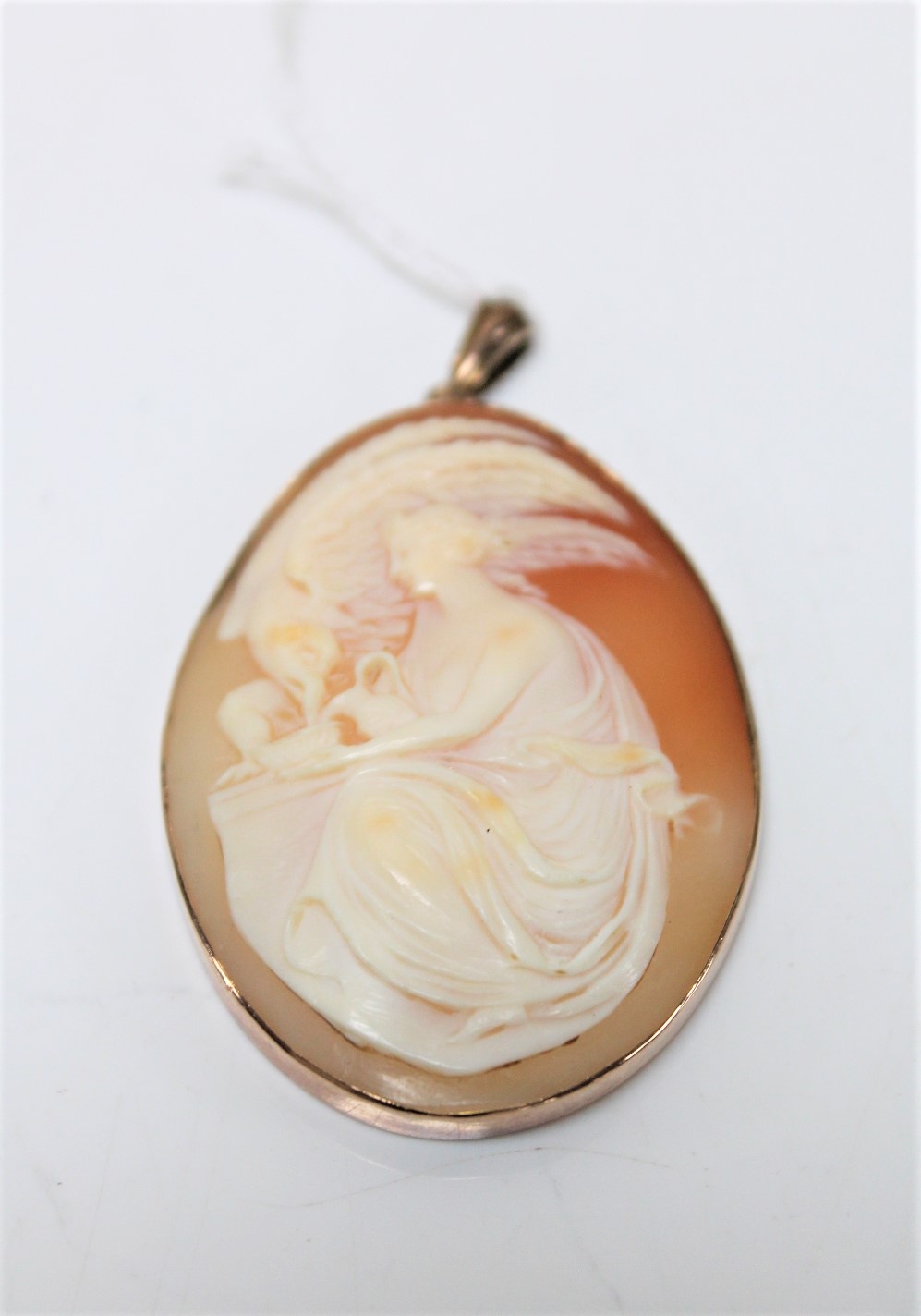 An antique 9ct rose gold cameo pendant depicting Leda and the Swan