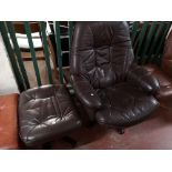 A brown leather relaxer chair with footstool.