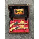 A pair of replica duelling pistols in fitted case