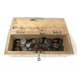 A wooden box with key containing a large quantity of Victorian and later coins