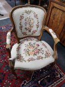 A walnut carved armchair with tapestry cover