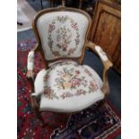 A walnut carved armchair with tapestry cover