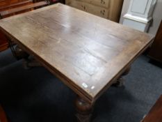 An early twentieth century oak extending bulbous legged dining table