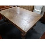 An early twentieth century oak extending bulbous legged dining table