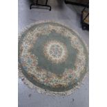 A fringed circular Chinese rug plus another