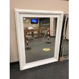 A painted white traditional style mirror,