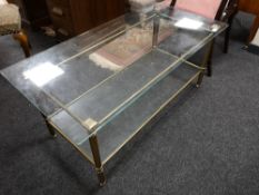 A glass topped brass coffee table
