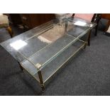 A glass topped brass coffee table