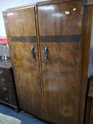 An early twentieth century walnut wardrobe and matching dressing table